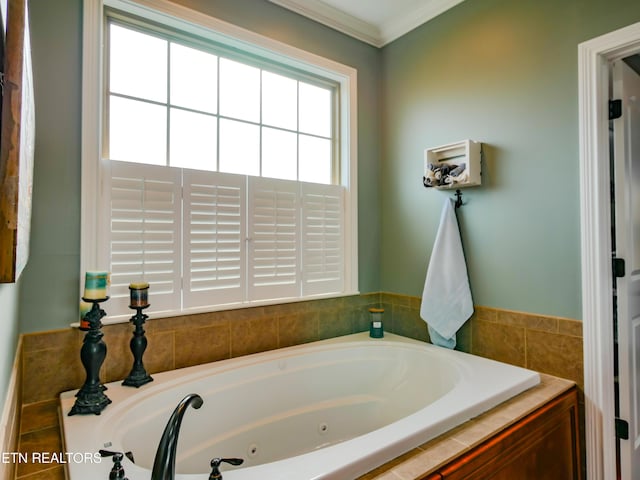 bathroom featuring ornamental molding, tiled bath, and a healthy amount of sunlight