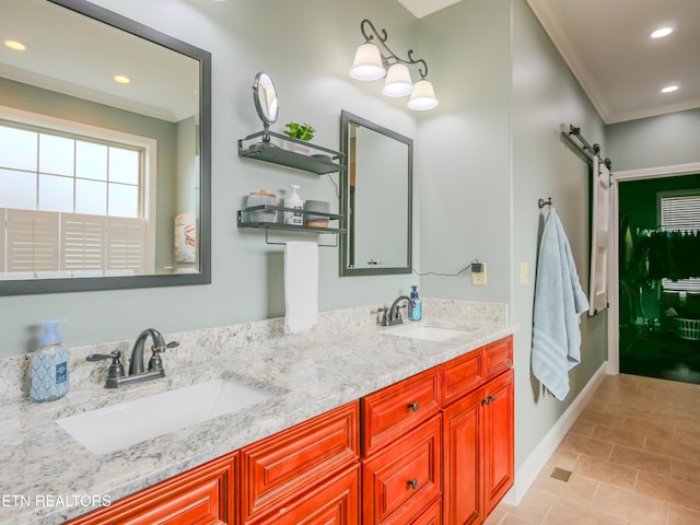 bathroom with crown molding, vanity, and tile patterned floors