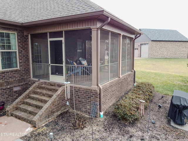 exterior space with a sunroom and a yard