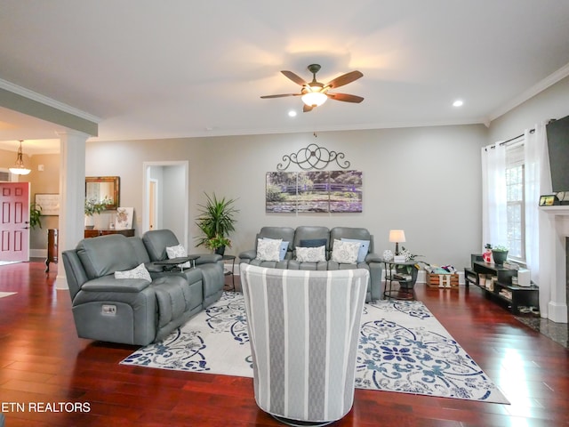 living room with ceiling fan, ornamental molding, dark hardwood / wood-style flooring, and decorative columns