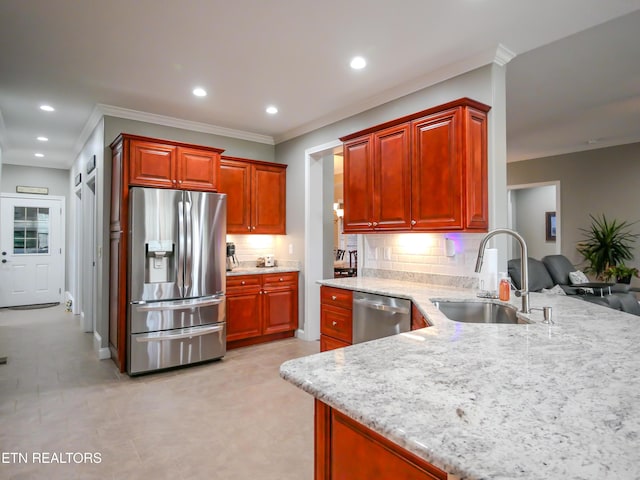 kitchen with sink, crown molding, appliances with stainless steel finishes, decorative backsplash, and kitchen peninsula