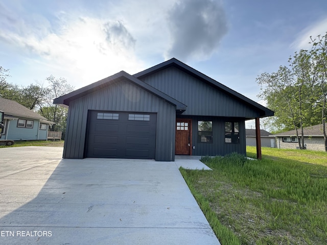 453 N Main St, Oneida, TN 37841 - view of front facade featuring board and batten siding, an attached garage, and driveway