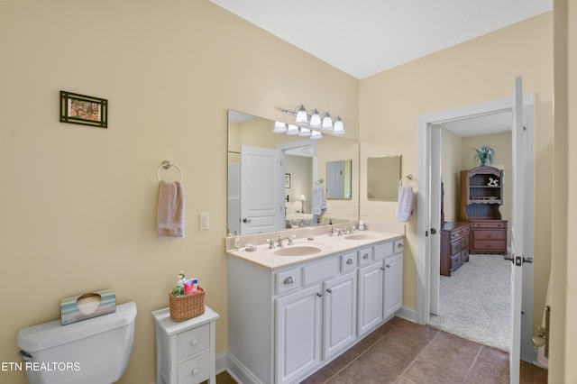 bathroom with vanity, tile patterned floors, and toilet