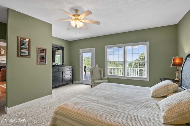 bedroom featuring light carpet, a textured ceiling, access to outside, and ceiling fan