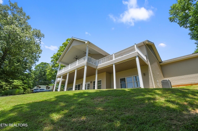 back of house featuring a yard, a balcony, and ceiling fan