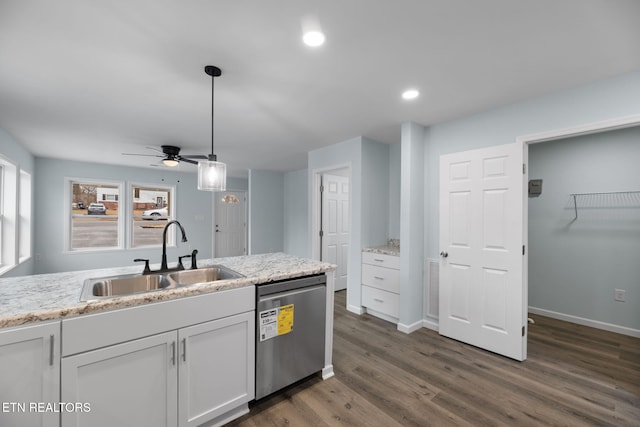 kitchen featuring sink, dishwasher, light stone countertops, white cabinets, and decorative light fixtures