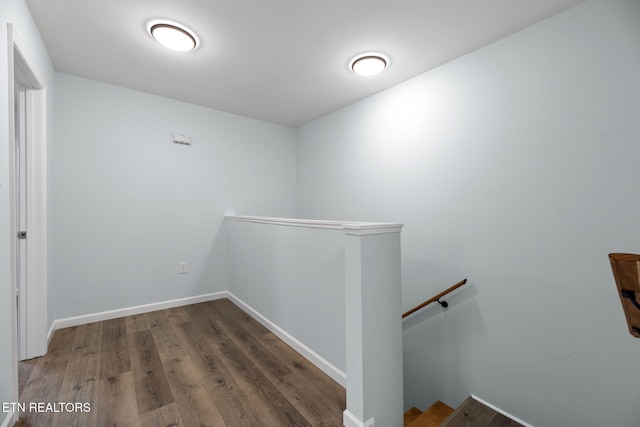 corridor with hardwood / wood-style floors