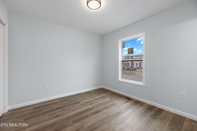 empty room featuring wood-type flooring