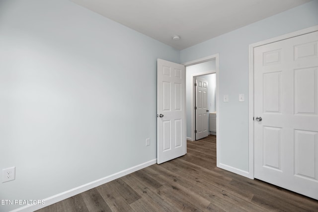 unfurnished bedroom featuring dark wood-type flooring