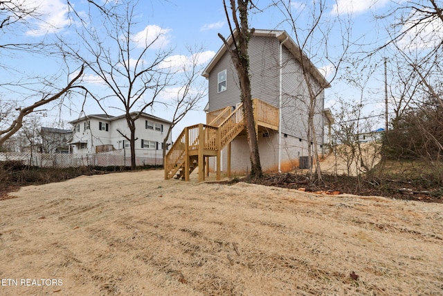 rear view of house with central AC unit