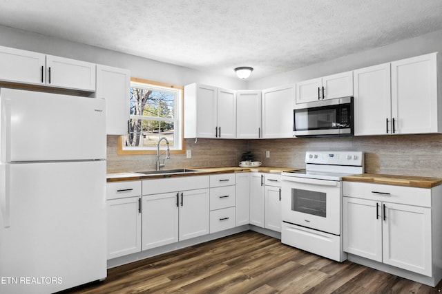 kitchen featuring sink, white appliances, dark wood-type flooring, and white cabinets