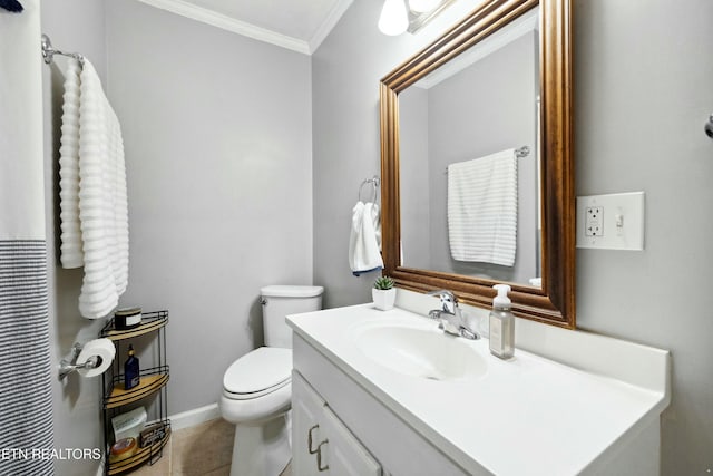 bathroom featuring vanity, ornamental molding, tile patterned floors, and toilet