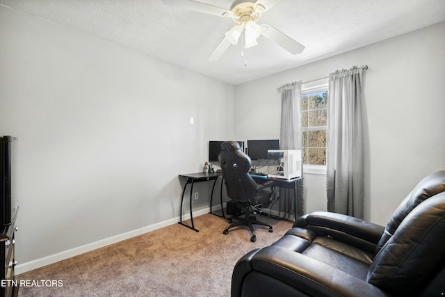 carpeted office space featuring a textured ceiling and ceiling fan