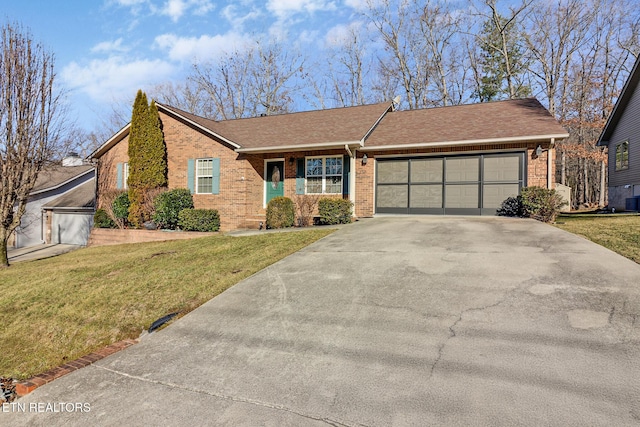 ranch-style home with a garage, a front yard, and cooling unit