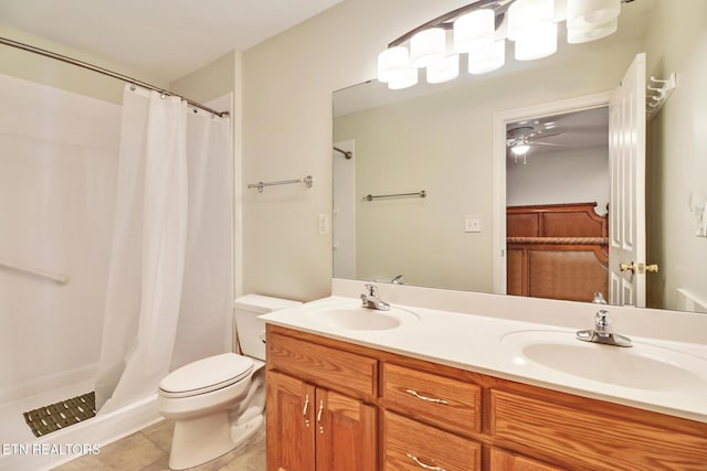 bathroom with tile patterned flooring, vanity, curtained shower, and toilet