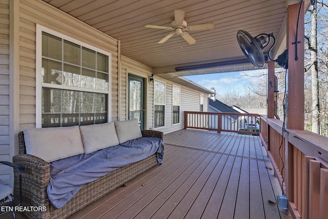 wooden terrace featuring ceiling fan and outdoor lounge area