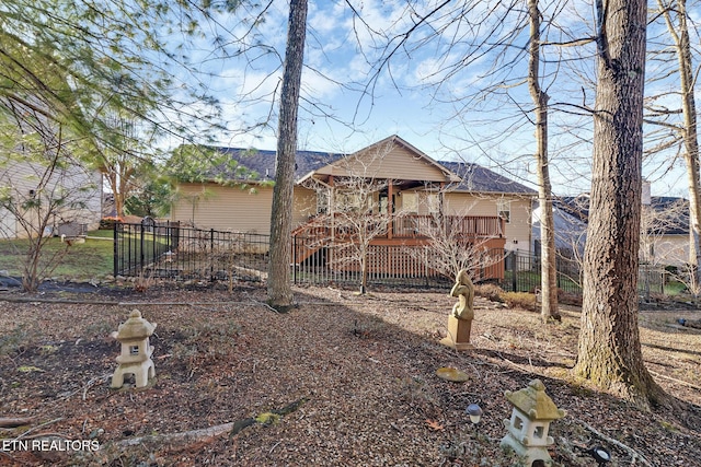 rear view of property with a wooden deck