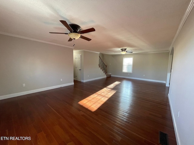 spare room featuring ornamental molding, dark hardwood / wood-style floors, and a textured ceiling