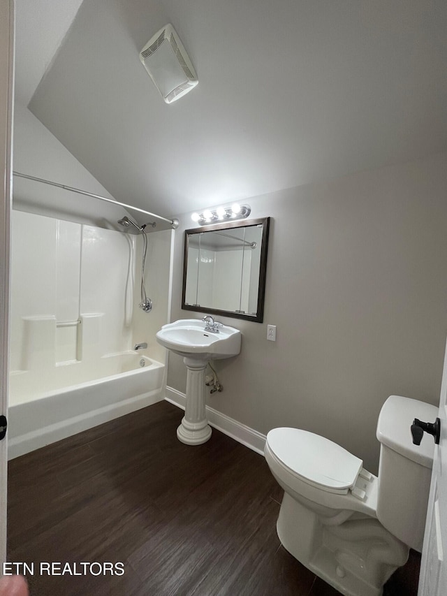 full bathroom featuring sink, wood-type flooring, bathtub / shower combination, and toilet