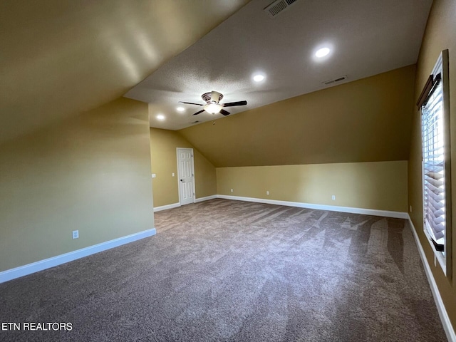 additional living space featuring vaulted ceiling, ceiling fan, and carpet flooring