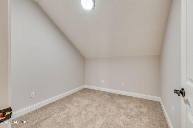 bonus room featuring light colored carpet and lofted ceiling