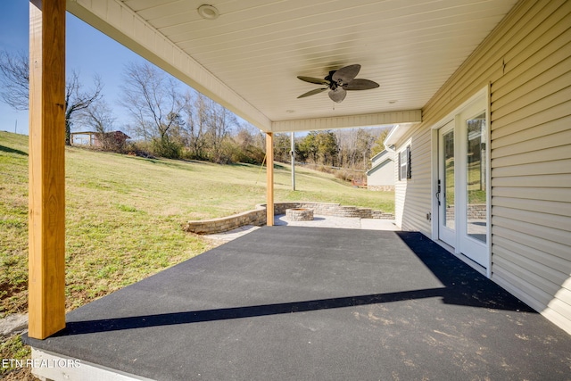 view of patio / terrace featuring ceiling fan and a fire pit
