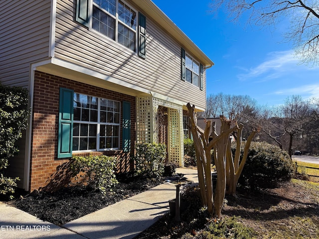 exterior space featuring brick siding