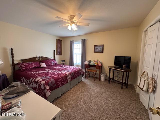 carpeted bedroom featuring ceiling fan