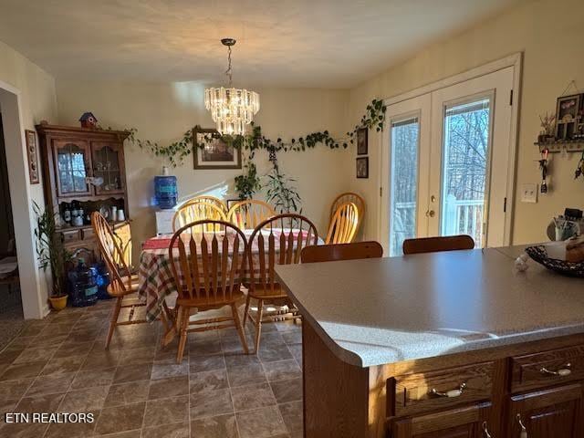 dining space with a notable chandelier and french doors