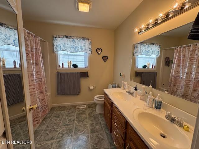 bathroom featuring vanity, a shower with shower curtain, and toilet