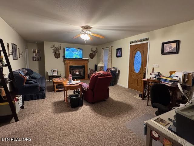 carpeted living room with ceiling fan