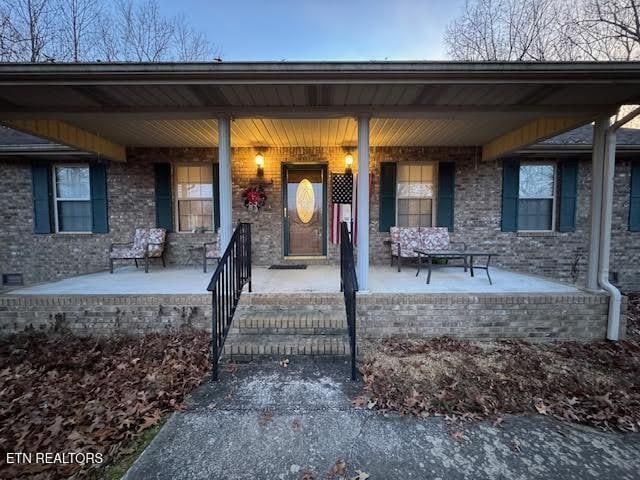 doorway to property with a porch