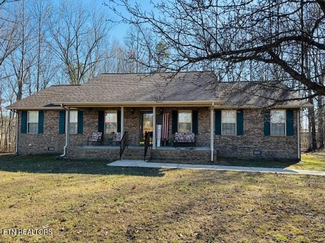 single story home with brick siding, crawl space, and a front yard