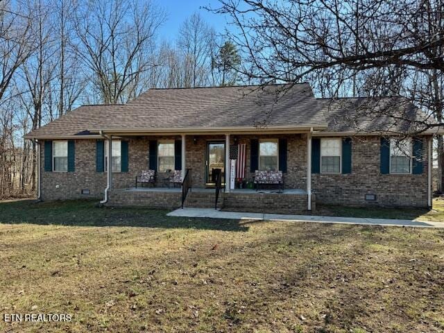 single story home with crawl space, roof with shingles, a front yard, and brick siding