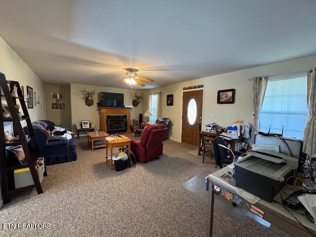 1039 S Ln, Grimsley, TN 38565 - carpeted living room featuring a ceiling fan and a glass covered fireplace