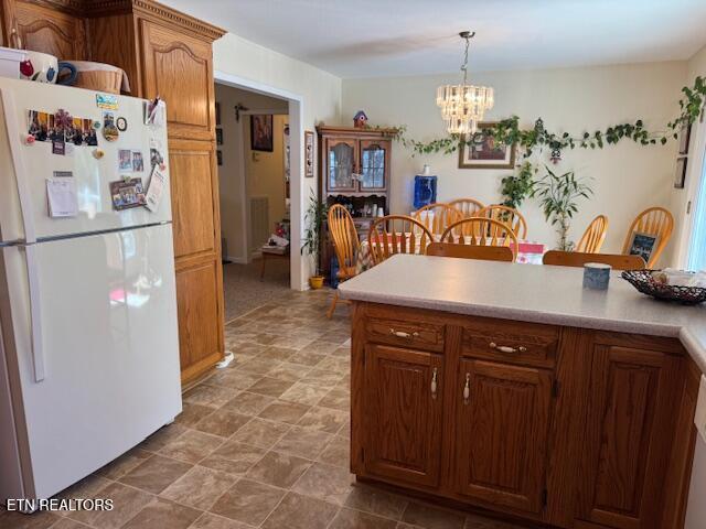 1039 S Ln, Grimsley, TN 38565 - kitchen featuring freestanding refrigerator, a chandelier, light countertops, and pendant lighting