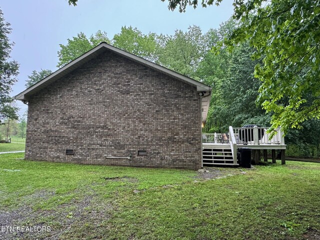 1039 S Ln, Grimsley, TN 38565 - view of side of property featuring a yard, a wooden deck, and brick siding