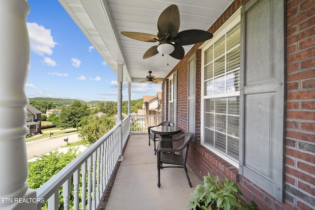 balcony with a porch and ceiling fan