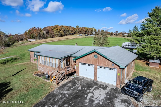 view of front of property with a garage and a front lawn