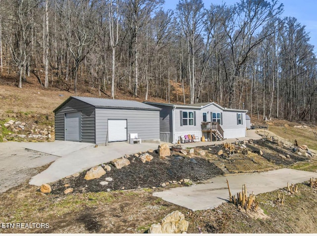 view of front of home featuring a garage and an outdoor structure