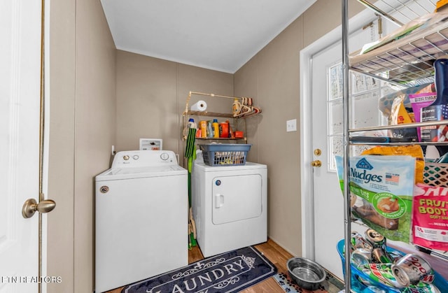 washroom with wood-type flooring and washer and dryer