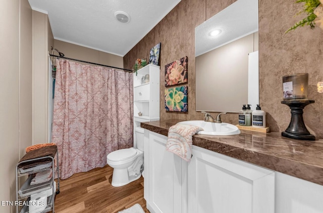 bathroom featuring ornamental molding, vanity, toilet, and hardwood / wood-style floors