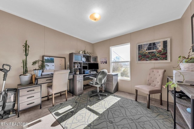 carpeted office with vaulted ceiling