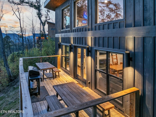 deck at dusk with area for grilling