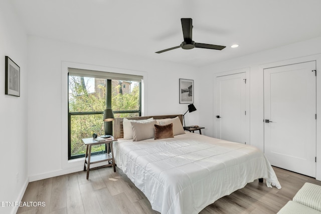 bedroom with ceiling fan and light wood-type flooring