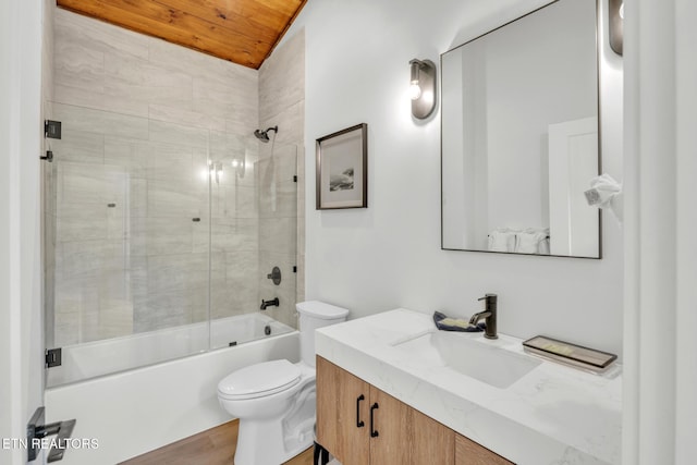 full bathroom with vanity, toilet, tiled shower / bath combo, and wooden ceiling