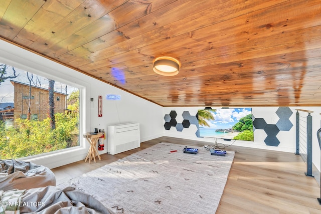 interior space with vaulted ceiling, crown molding, light hardwood / wood-style floors, and wooden ceiling