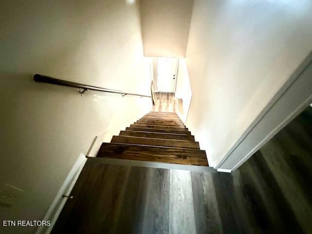 stairs featuring wood-type flooring