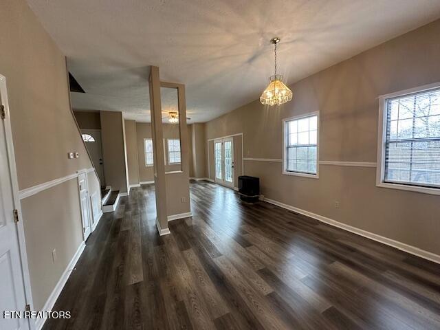 unfurnished living room featuring dark hardwood / wood-style flooring