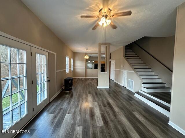 interior space featuring dark hardwood / wood-style flooring, ceiling fan, and a healthy amount of sunlight